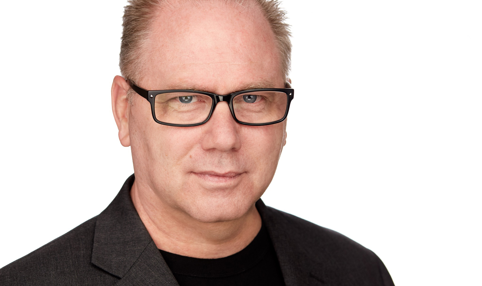 A man with glasses and a jacket on